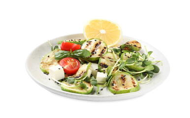 Delicious grilled zucchini slices served with feta cheese, tomatoes and lemon on white background