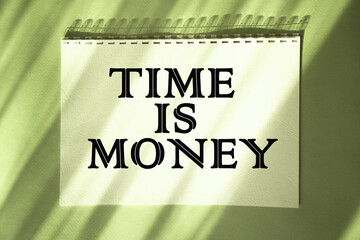 TIME IS MONEY. Saying. expression written on a notepad