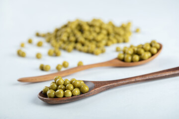 Pile of olives with wooden spoons on white background