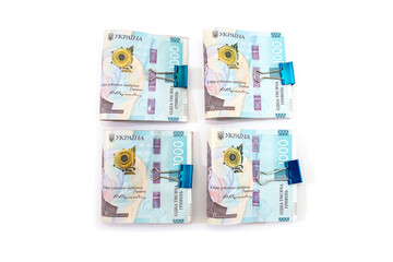 several 1000 hryvnia banknotes fastened with a clip on white. V