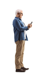 Full length profile shot of a mature man typing on a mobile phone