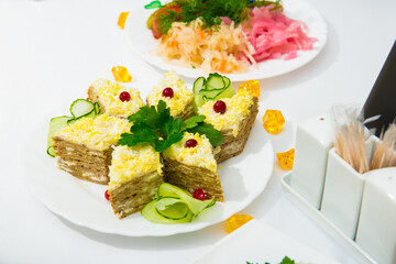 serving salad. salad in a restaurant on a table with a white tablecloth. Table served with dishes for the holiday 
