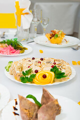 serving salad. salad in a restaurant on a table with a white tablecloth. Table served with dishes for the holiday 