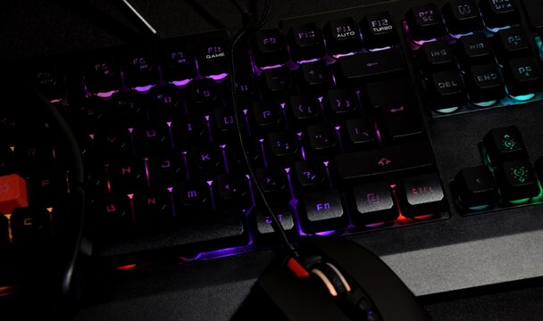 Backlit gaming keyboard, headphones, gaming mouse, computer gaming concept
