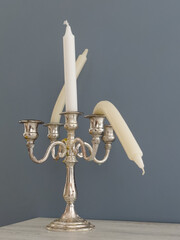 Candlestick with straight and bent candles. Metaphor of erectile dysfunction impotence. Creative...