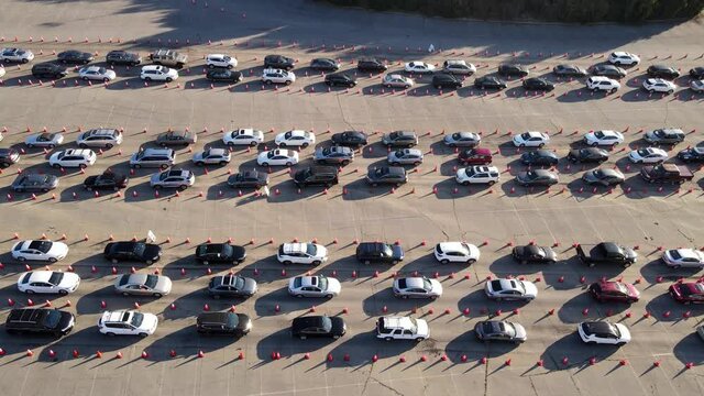 Aerial Shot Of 1000’s Of People In Cars Waiting In Line At A Drive-through Testing Site To Be Tested For Coronavirus Or To Receive The Vaccine.
