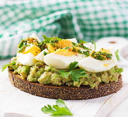 Vegetarian breakfast. Sandwich with avocado puree and boiled eggs.  Healthy breakfast or lunch.