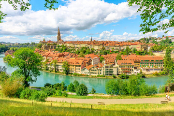 Obraz premium Aerial view of cityscape of old town of Bern, Switzerland, with Cathedral Bell Tower and Aare river. Popular landmark of historical town UNESCO World Heritage. Skyline of medieval houses.