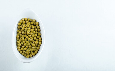 Top view of marinated green olives in white bowl