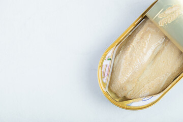 Top view Canned Tuna chunk in can, open canned food with lid cover is opened.