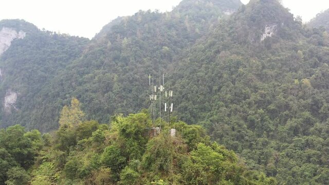 Communication base stations and antennas on a mountain top in karst terrain