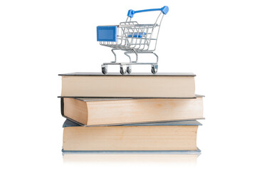 Shopping cart on top of a pile of books with reflection on white background