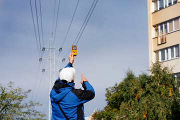 Electromagnetic radiation measuring under high voltage power transmission towers among buildings