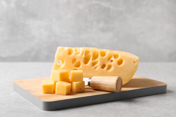 Tasty fresh cheese with fork on grey table