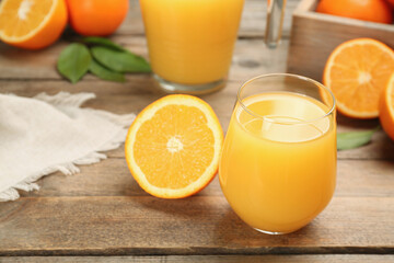 Delicious orange juice and fresh fruit on wooden table