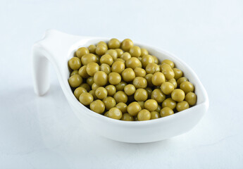 Close up photo of marinated olives in white bowl over white background