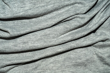 wrinkled gray cotton fabric with many folds