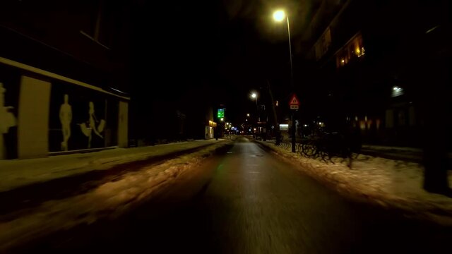 Netherlands - 10 februari 2021, Hilversum: Night-time curfew during corona time POV driving through empty streets