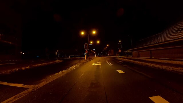 Netherlands - 10 februari 2021, Hilversum: Night-time curfew during corona time POV driving through empty streets