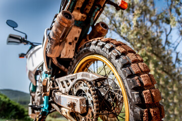 Back view of a dirt bike in the mud