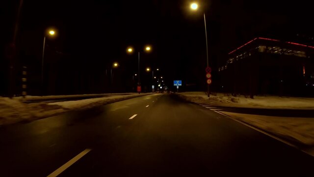 Netherlands - 10 februari 2021, Hilversum: Night-time curfew during corona time POV driving through empty streets