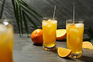 Delicious orange soda water on grey table