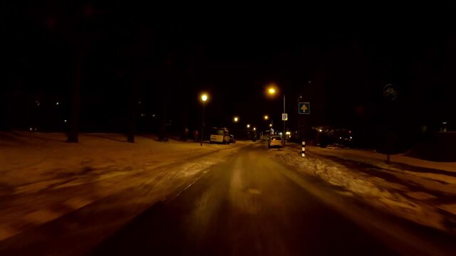 Netherlands - 10 februari 2021, Hilversum: Night-time curfew during corona time POV driving through empty streets