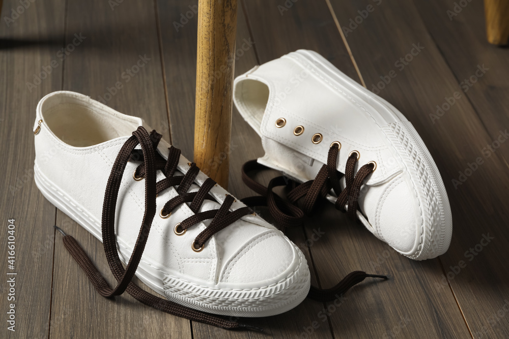 Canvas Prints Pair of stylish shoes with brown laces on wooden floor indoors