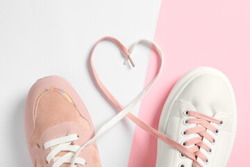 Pair of stylish shoes with laces on color background, flat lay