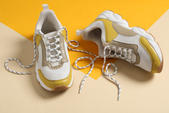 Pair Of Stylish Shoes With Laces On Color Background