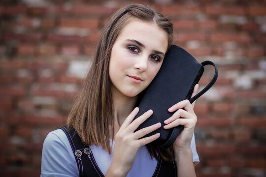 Young Teen Girl Holding Small Black Purse