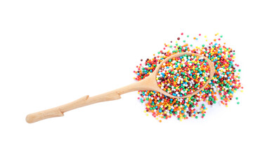 Colorful sprinkles in spoon on white background, top view. Confectionery decor