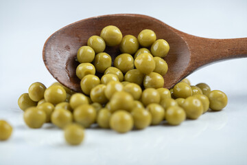 Green olives on white background. wooden spoon