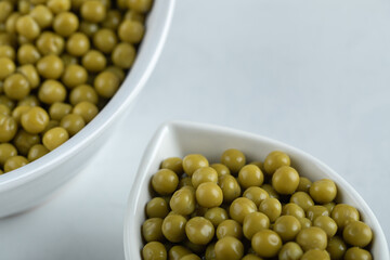 Close up photo of green olives in white bowls