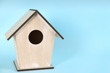 Obraz na płótnie Canvas Beautiful bird house on light blue background, space for text