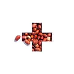 Plus summation sign or cross of peanuts and cut paper isolated on white. Nuts typeface made of groundnut