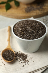 Chia seeds in bowl and spoon on table