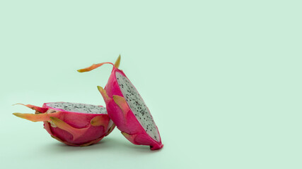 Two halves of Ripe dragon fruit with white flesh. The pink pitaya fruit is low in calories, rich in...