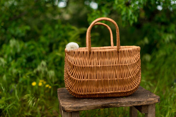 a basket with blowball standing on the old chair.Herb,organic,poscards.