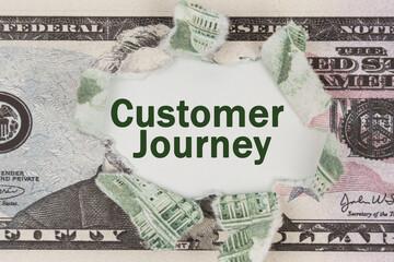 The dollar is torn in the center. In the center it is written - Customer Journey