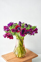 Magenta and violet gradient poppies anemones. Many flowers - great background. the work of the florist at a flower shop. Delivery fresh cut flower. European floral shop.