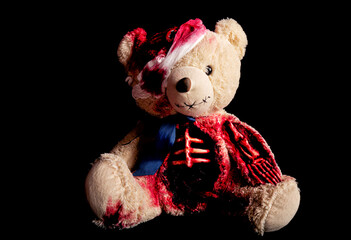 bear on a black background with a broken head. with a bandaged eye. a skeletal hand and a torn...