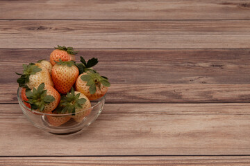 pineberries in a glass bowl, pineberries on wood, pineberry, isolated, white background, black background