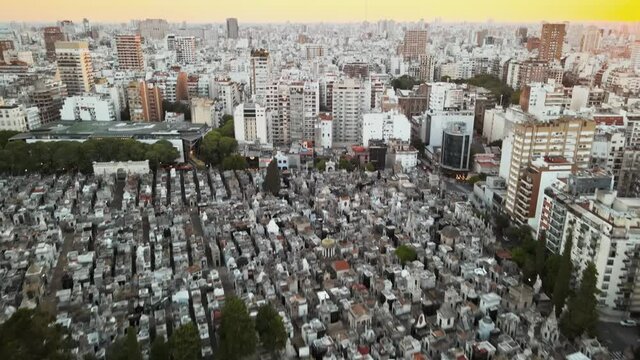 Aerial tilt up shot revealing La Recoleta Cemetery at sunset in Buenos Aires