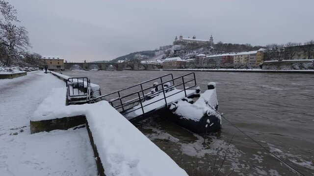 Floating dock on the River Main, in the background the Festung Marienberg and Alte Mainbr&uuml;cke. Cold cloudy winter day in W&uuml;rzburg. This beautiful historical german city is very rarely coverd in snow.