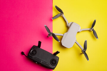 Quadrocopter on the background . Drone. Drone on a pink background. An article about modern technologies. Modern cameras. Shooting from the air. Article about choosing a quadrocopter. Copy space