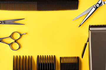 top view of hairdressing equipment on a yellow background with copy space
