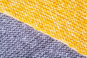 Knitted patterns of gray and yellow yarn, knitted plaid. Needlework, handicrafts, hobbies, creativity, DIY