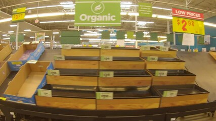 Mostly empty produce bins at the grocery store days after devastating winter storm Uri; food shortages managed thru purchase limits and reduced store hours