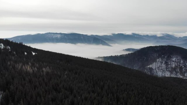 Aerial view of a sea of clouds over the mountains valley in the Carpathians